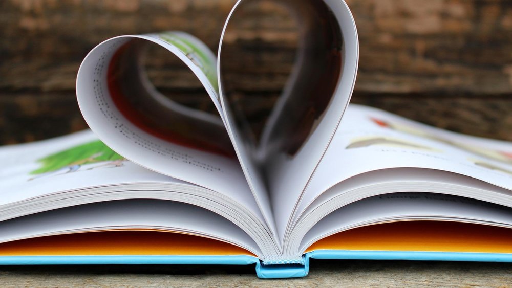 a book with its pages folded into the shape of a heart